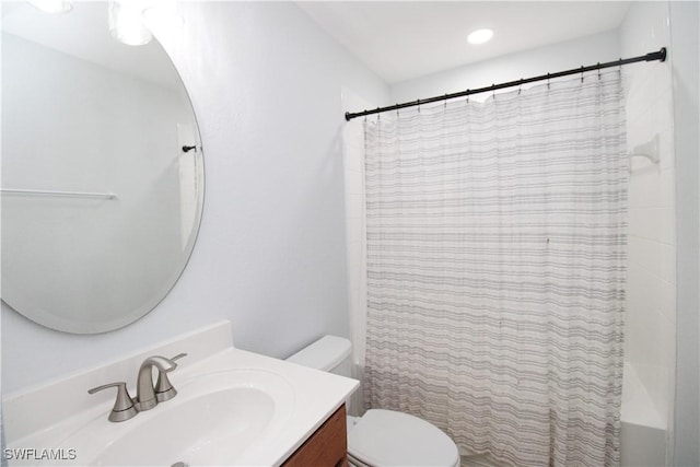 bathroom featuring vanity, toilet, and walk in shower