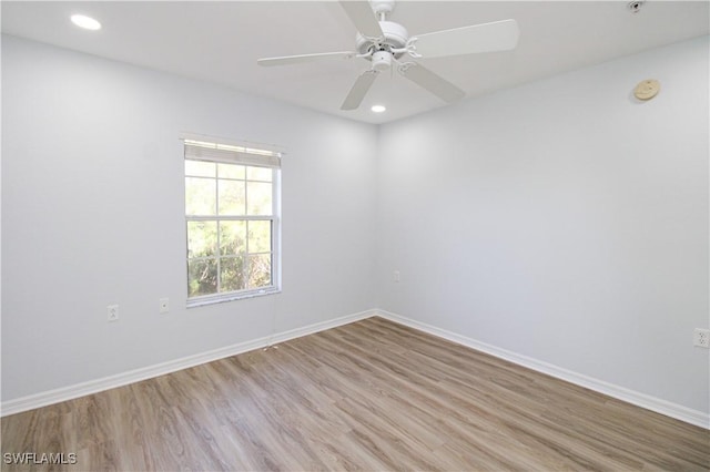 spare room featuring light hardwood / wood-style flooring and ceiling fan