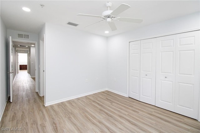 unfurnished bedroom with light wood-type flooring, a closet, and ceiling fan