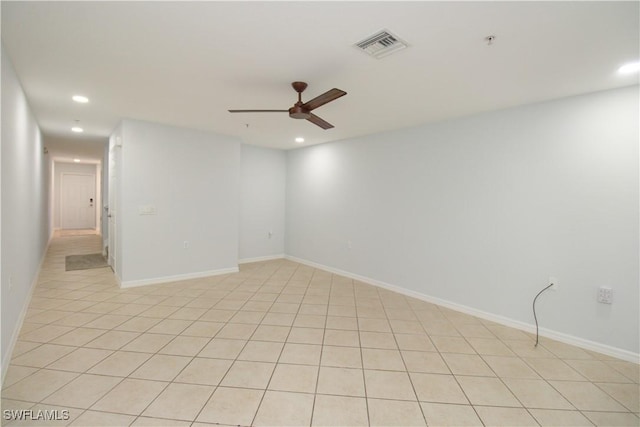 empty room featuring light tile patterned flooring and ceiling fan