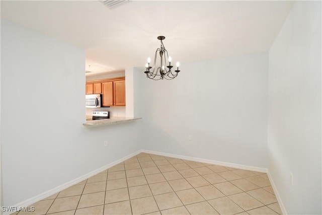 unfurnished dining area with a chandelier and light tile patterned flooring