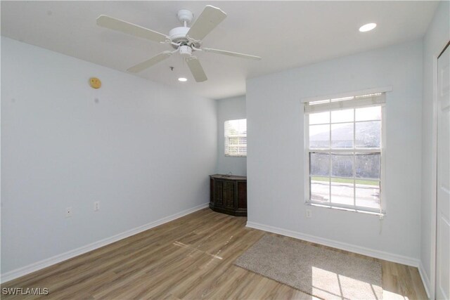 empty room featuring ceiling fan and light hardwood / wood-style floors