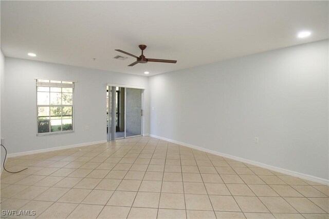 tiled empty room with ceiling fan