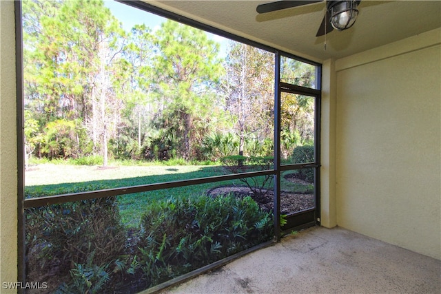 unfurnished sunroom with ceiling fan