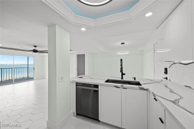 kitchen with white cabinetry, a water view, dishwasher, and light stone counters