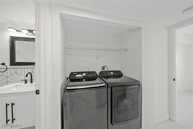 laundry area with washing machine and dryer and sink