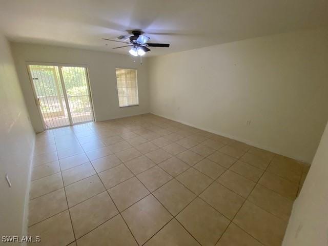 tiled empty room with ceiling fan