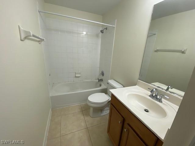 full bathroom with toilet, vanity, tile patterned floors, and tiled shower / bath combo