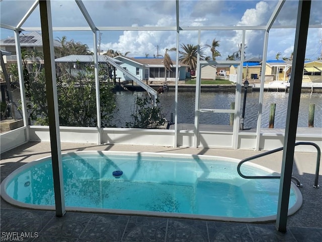 view of pool with a boat dock, a water view, and a lanai