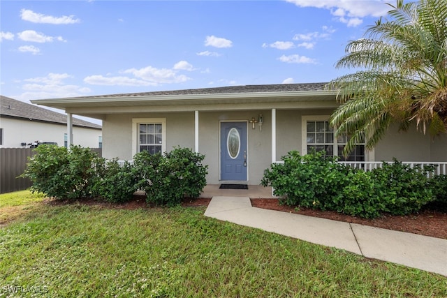 view of front of property with covered porch and a front lawn