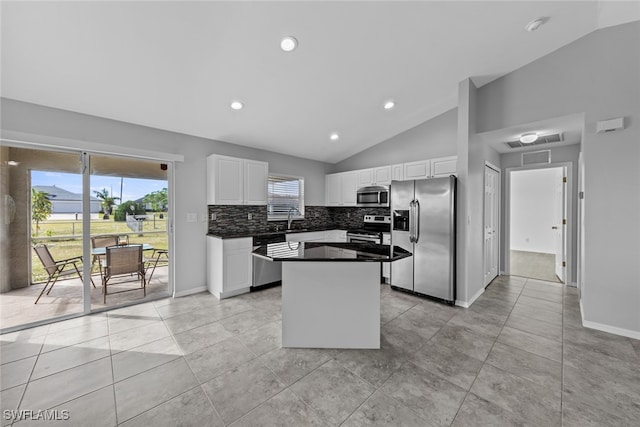 kitchen featuring white cabinets, a center island, stainless steel appliances, and sink