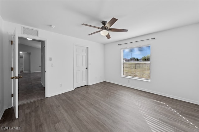 unfurnished bedroom featuring ceiling fan, dark hardwood / wood-style flooring, and a closet