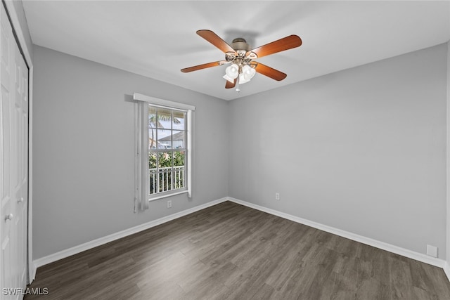 empty room featuring dark hardwood / wood-style floors and ceiling fan