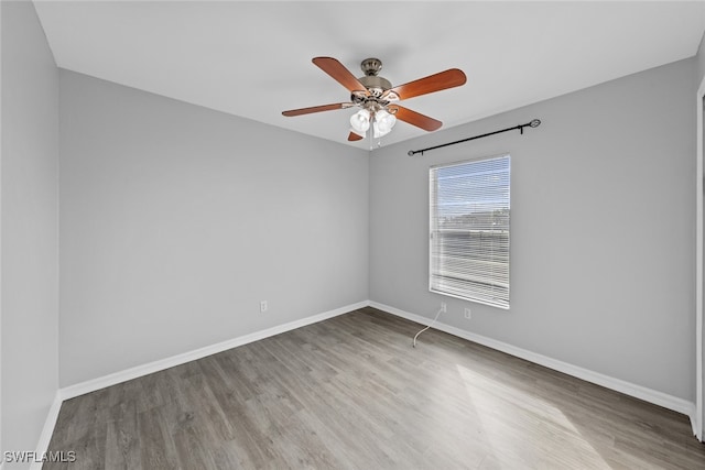 empty room featuring ceiling fan and light hardwood / wood-style floors