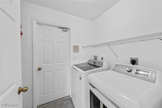 laundry room with independent washer and dryer