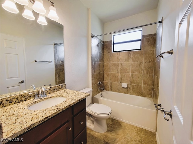 full bathroom with toilet, vanity, and tiled shower / bath