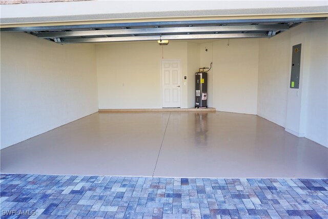 garage featuring electric panel and water heater