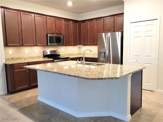 kitchen with sink, an island with sink, light stone counters, and appliances with stainless steel finishes