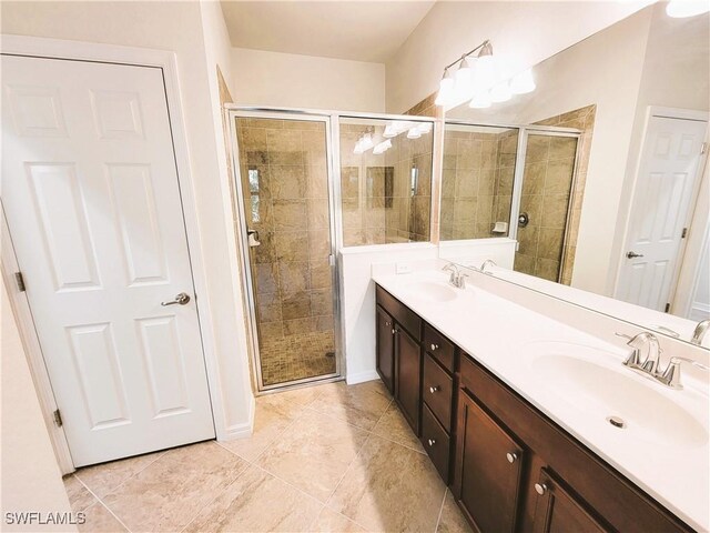 bathroom with a shower with door and vanity