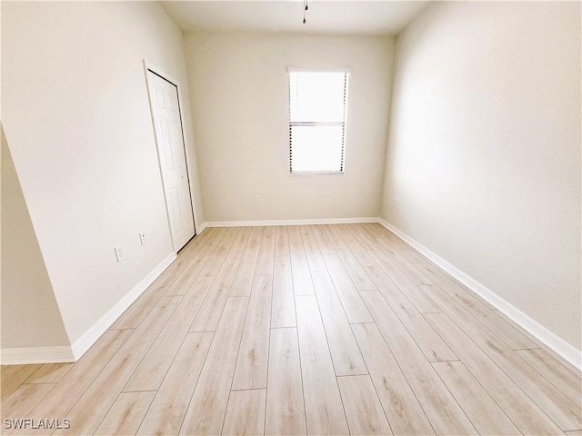 unfurnished room with light hardwood / wood-style floors