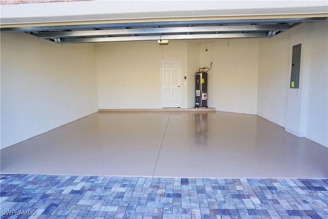 garage featuring electric panel and electric water heater