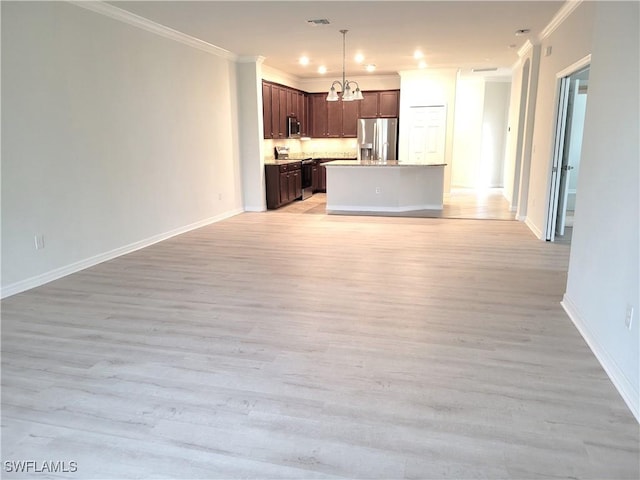 kitchen featuring light wood-type flooring, a kitchen island, and appliances with stainless steel finishes