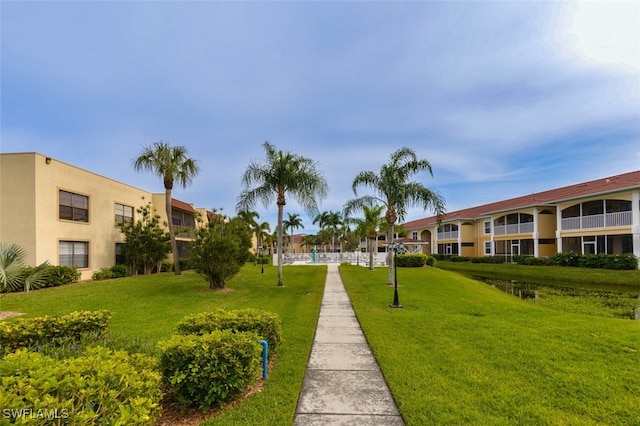 view of property's community with a lawn