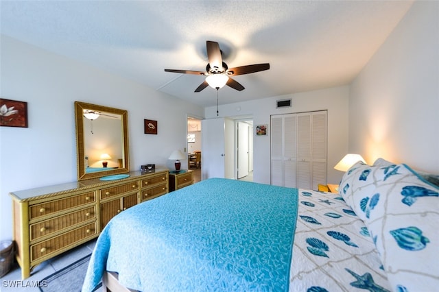 bedroom with ceiling fan and a closet