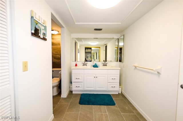 bathroom with tile patterned floors, vanity, and toilet