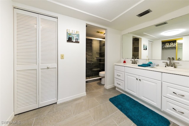 bathroom featuring tile patterned floors, vanity, toilet, and an enclosed shower