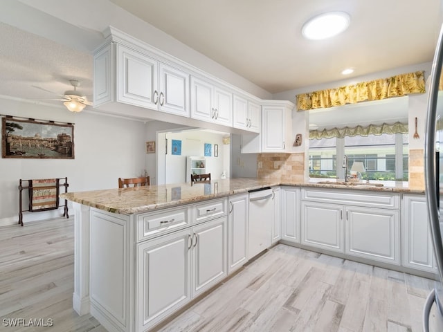 kitchen featuring white cabinets, ceiling fan, dishwasher, and kitchen peninsula