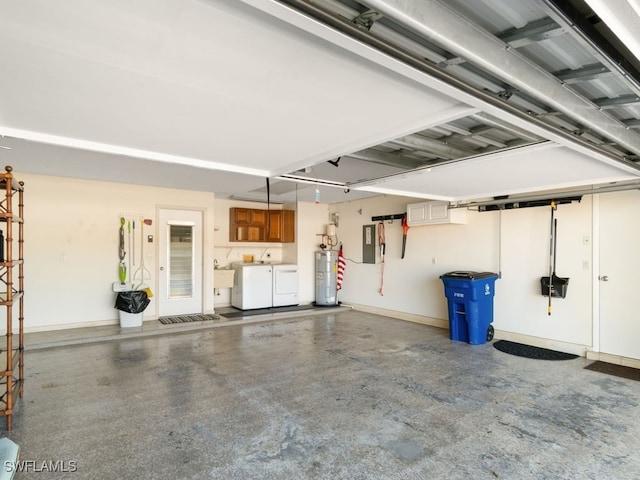 garage featuring separate washer and dryer, water heater, and sink