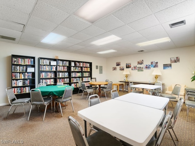 interior space featuring a drop ceiling and carpet