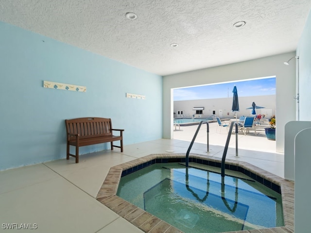 view of swimming pool featuring an indoor hot tub