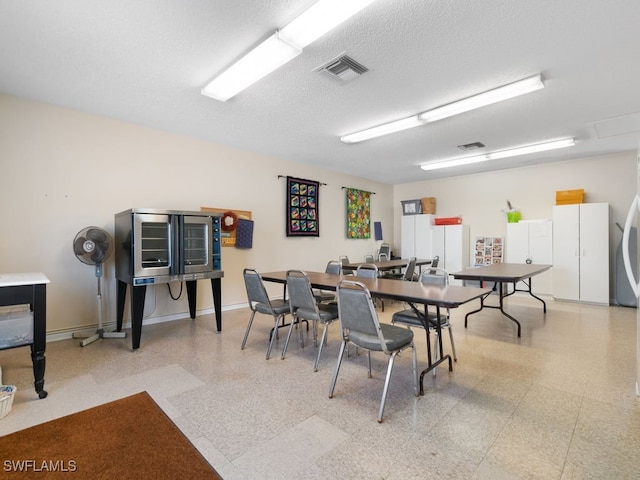 dining room featuring a textured ceiling