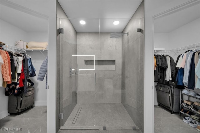 bathroom with a shower with door