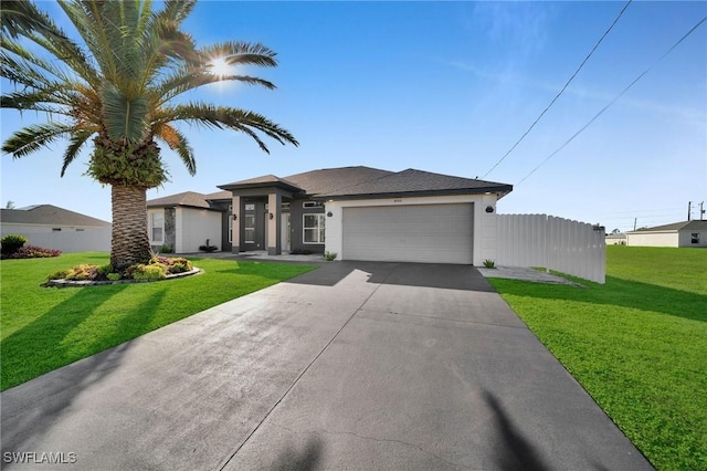 view of front of house featuring a garage and a front yard