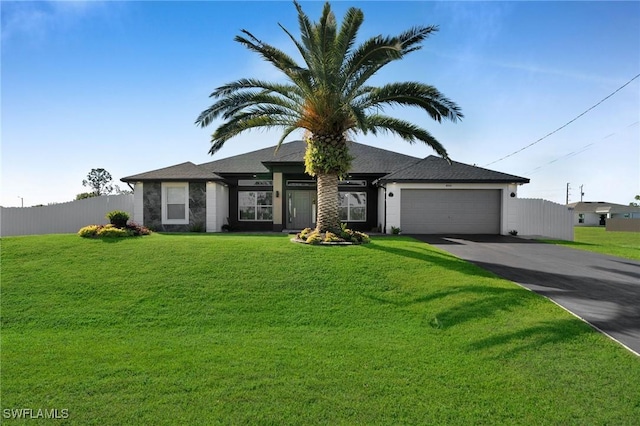 view of front of house featuring a garage and a front lawn