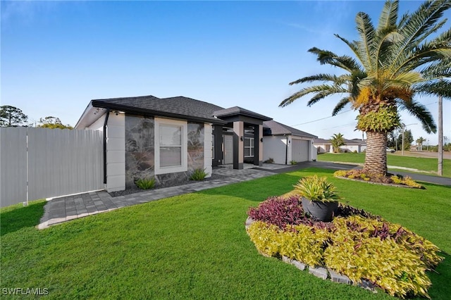 view of front facade with a garage and a front yard