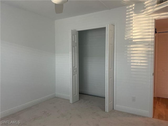 2876 Oleander St Unit D3, Saint James City, FL 33956 - unfurnished bedroom with carpet floors, a closet, and a ceiling fan