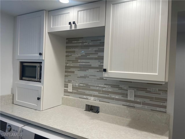 kitchen with white cabinetry and tasteful backsplash