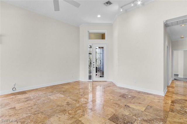 unfurnished room featuring ceiling fan, baseboards, visible vents, and ornamental molding