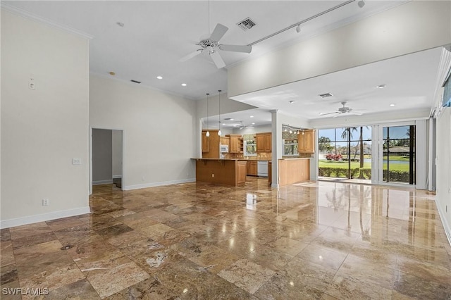 unfurnished living room with ceiling fan, baseboards, and ornamental molding