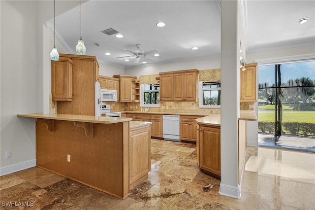 kitchen with kitchen peninsula, tasteful backsplash, white appliances, pendant lighting, and a breakfast bar area