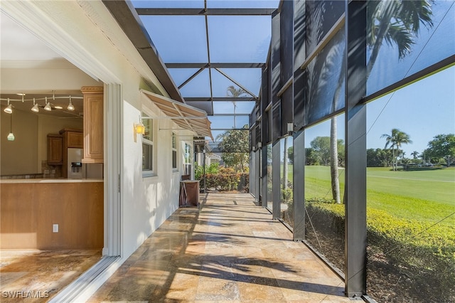 view of patio featuring a lanai