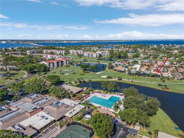 aerial view featuring golf course view, a water view, and a residential view