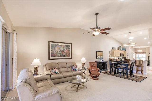 carpeted living room with vaulted ceiling and ceiling fan