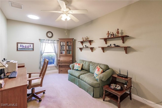 carpeted office space featuring ceiling fan