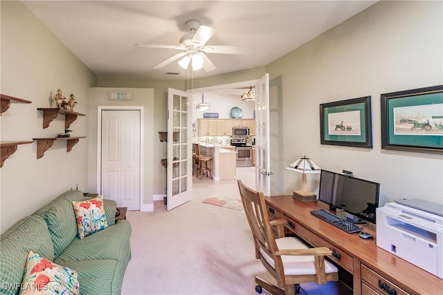 office area with french doors, light colored carpet, and ceiling fan