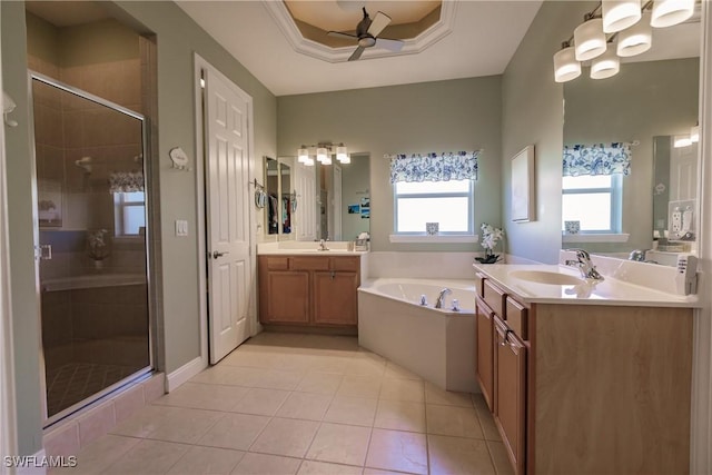 bathroom with ceiling fan, vanity, a raised ceiling, tile patterned floors, and shower with separate bathtub